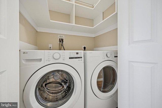 clothes washing area with laundry area and washing machine and dryer