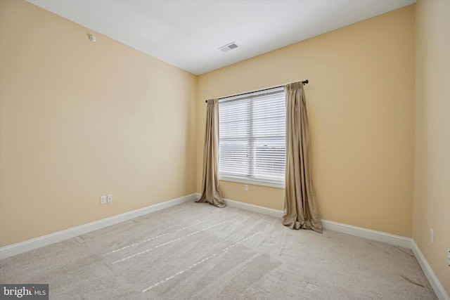 empty room with visible vents, carpet flooring, and baseboards