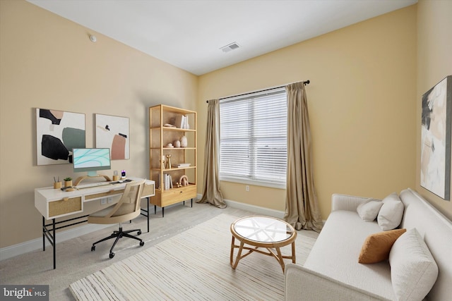 office area featuring light colored carpet, baseboards, and visible vents