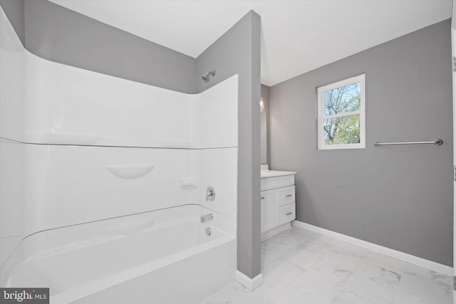 full bathroom with baseboards, shower / tub combination, marble finish floor, and vanity