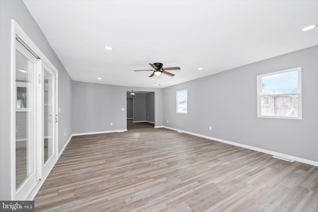 unfurnished room with visible vents, a ceiling fan, recessed lighting, light wood finished floors, and baseboards