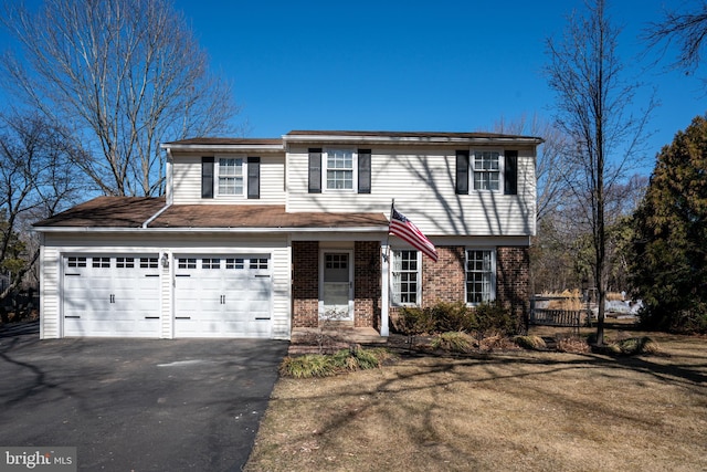 view of front of property featuring brick siding and driveway