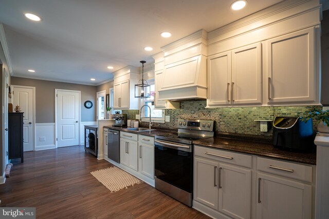 kitchen with dark wood-style flooring, a sink, white cabinets, appliances with stainless steel finishes, and backsplash