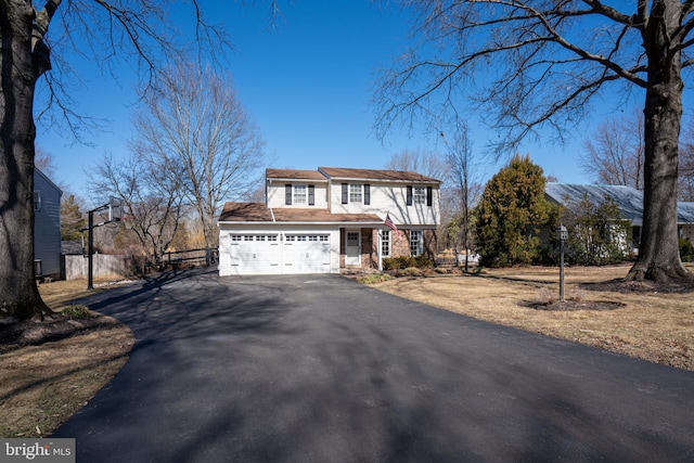 view of front of home featuring fence and driveway