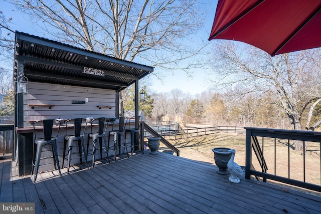 deck with outdoor dry bar and fence