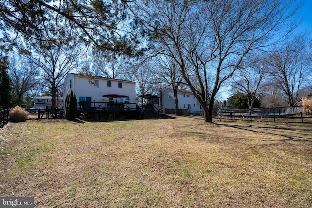 view of yard with stairway, fence, and a wooden deck