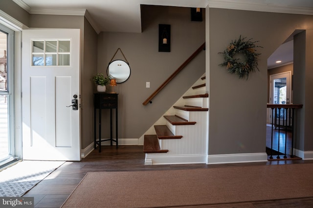 entryway with ornamental molding, stairs, baseboards, and wood finished floors