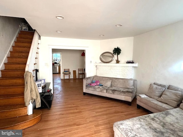 living room with light wood finished floors, stairway, and recessed lighting