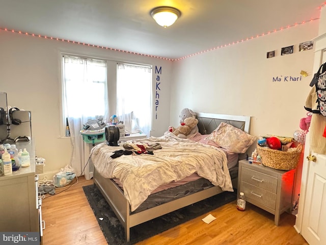 bedroom featuring light wood-style flooring