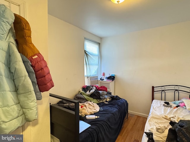 bedroom with wood finished floors and baseboards