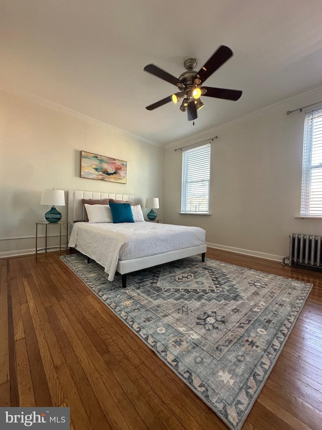 bedroom with hardwood / wood-style flooring, radiator heating unit, baseboards, and ornamental molding