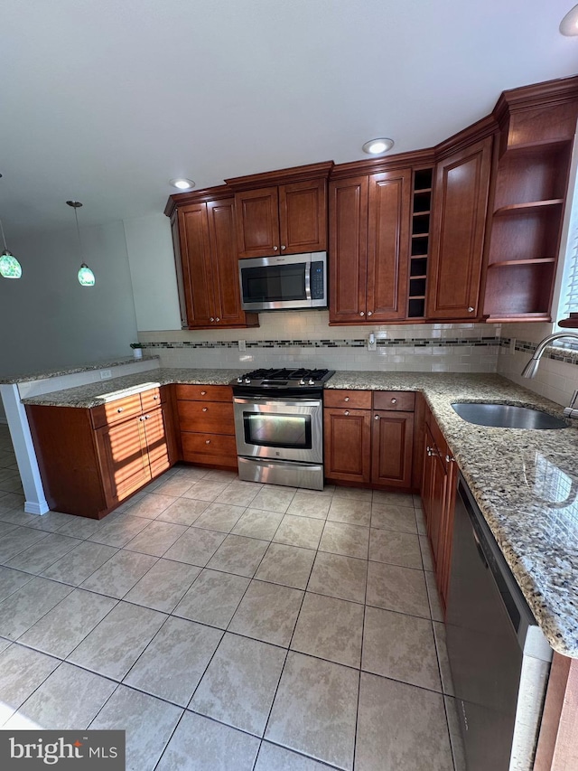 kitchen featuring open shelves, a peninsula, a sink, decorative backsplash, and appliances with stainless steel finishes