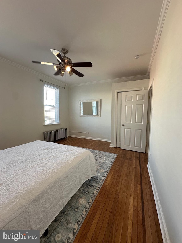 bedroom with baseboards, dark wood-type flooring, radiator, and ornamental molding