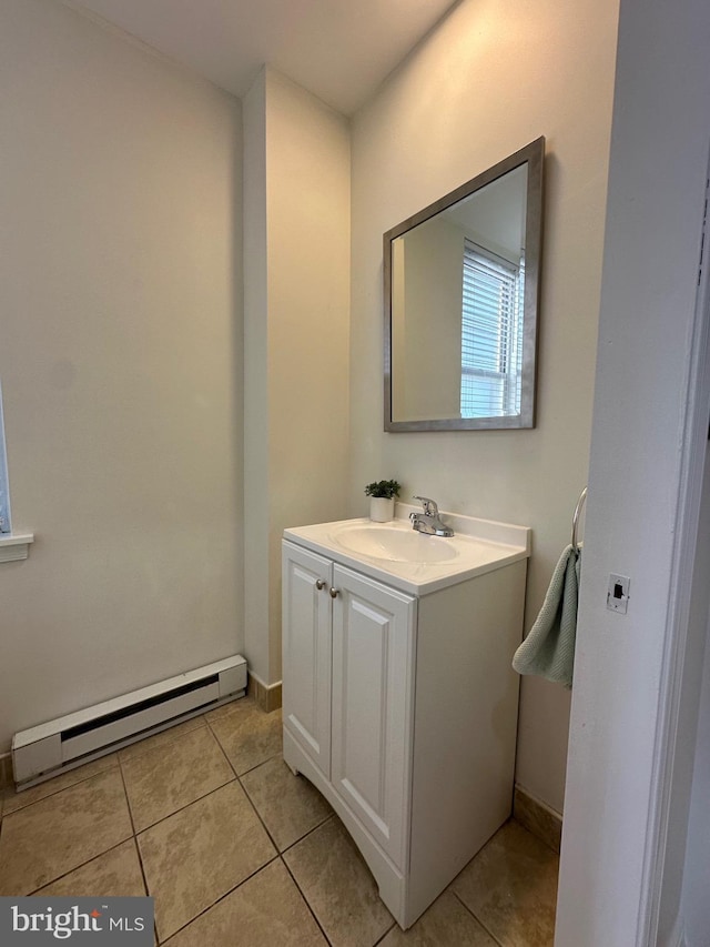 bathroom with a baseboard heating unit, vanity, baseboards, and tile patterned flooring