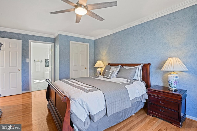 bedroom featuring wallpapered walls, baseboards, ornamental molding, light wood-style flooring, and ensuite bathroom