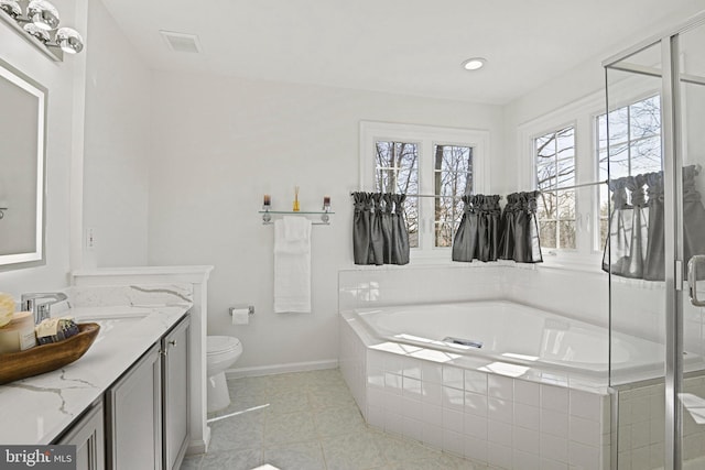 bathroom featuring visible vents, baseboards, toilet, a bath, and vanity