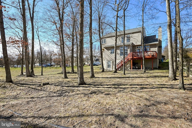 view of yard with stairway and a wooden deck