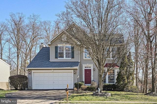 view of front of home featuring a front lawn, driveway, roof with shingles, a garage, and a chimney