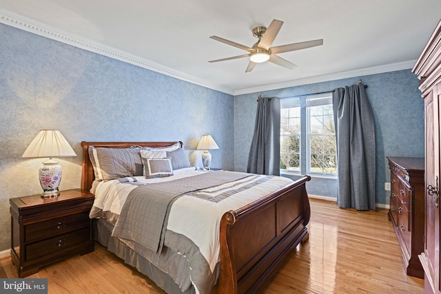 bedroom with crown molding, baseboards, light wood-type flooring, and ceiling fan