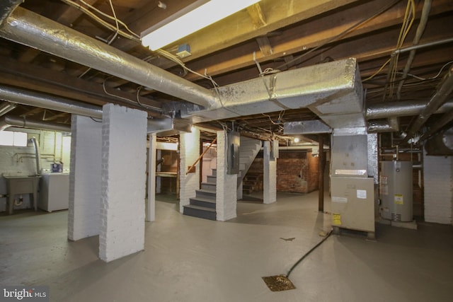 unfinished basement featuring heating unit, electric panel, washer / clothes dryer, stairs, and gas water heater