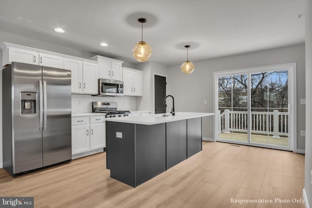 kitchen featuring a sink, stainless steel appliances, and white cabinets