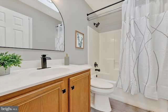 full bathroom with shower / bathtub combination with curtain, toilet, and vanity