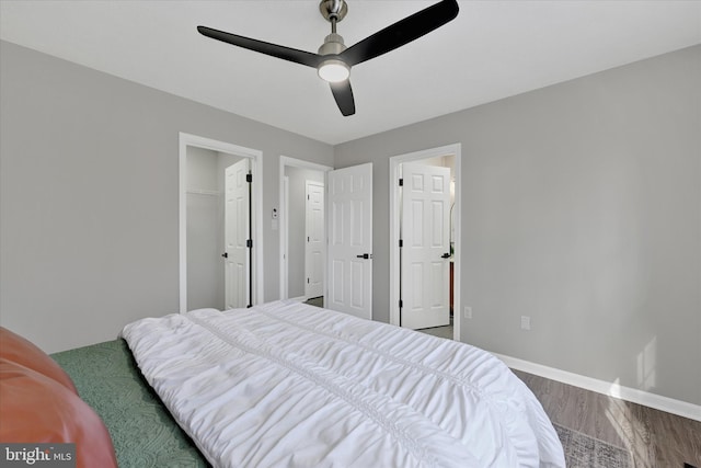 bedroom featuring wood finished floors, baseboards, a closet, and ceiling fan