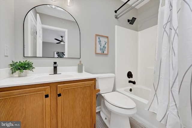 bathroom featuring vanity, toilet, a ceiling fan, and shower / bath combo