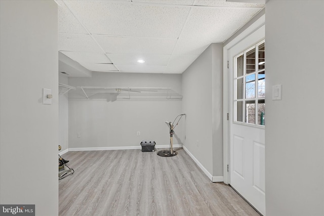 walk in closet featuring a drop ceiling and wood finished floors