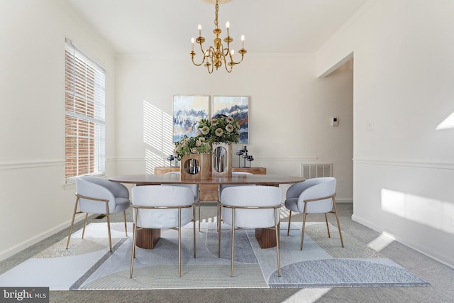 carpeted dining room with a notable chandelier, visible vents, baseboards, and ornamental molding