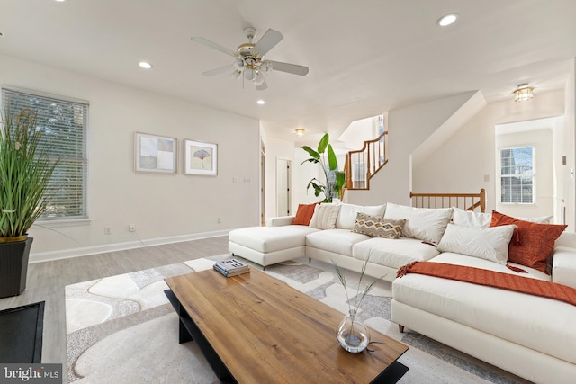 living area with baseboards, stairs, recessed lighting, light wood-style flooring, and a ceiling fan