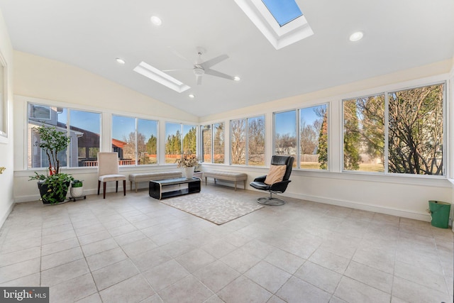 unfurnished sunroom featuring plenty of natural light, vaulted ceiling with skylight, and a ceiling fan