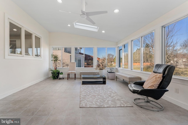 sunroom / solarium featuring lofted ceiling with skylight and ceiling fan