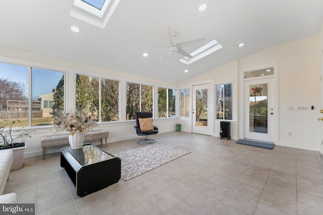 unfurnished sunroom featuring vaulted ceiling with skylight and a ceiling fan