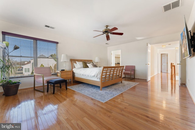 bedroom featuring light wood-style flooring, baseboards, and visible vents