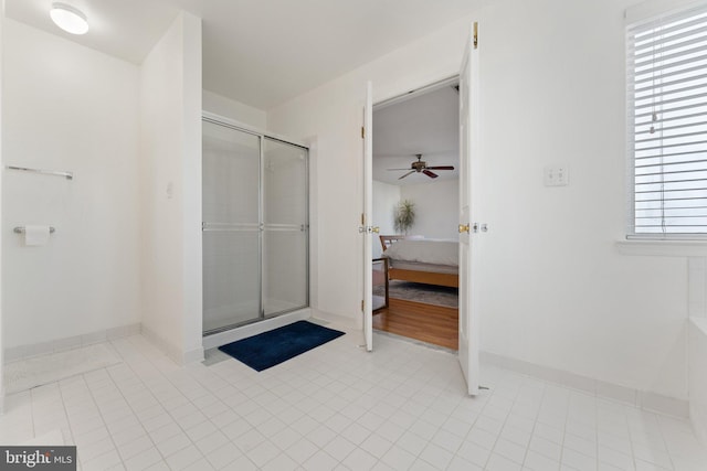 full bath featuring tile patterned flooring, a shower stall, ensuite bath, and a ceiling fan