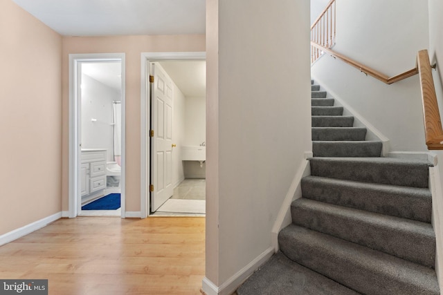 stairs featuring baseboards and wood finished floors