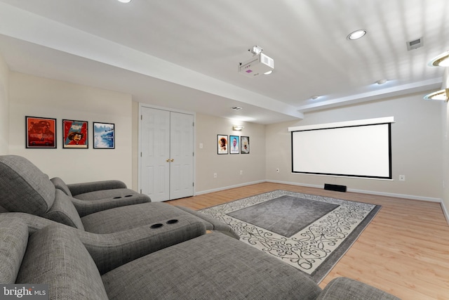 cinema room with baseboards and wood finished floors