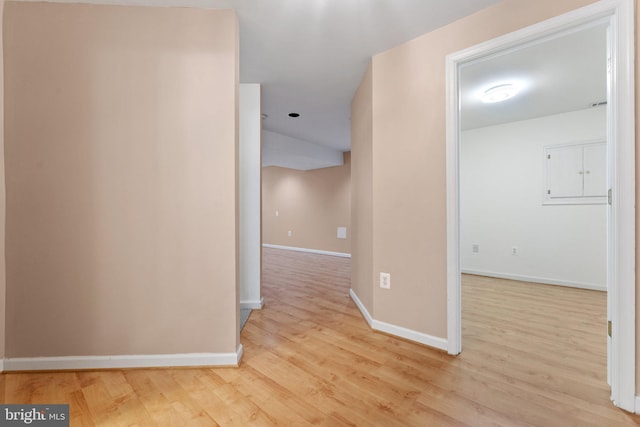 hallway with baseboards and wood finished floors