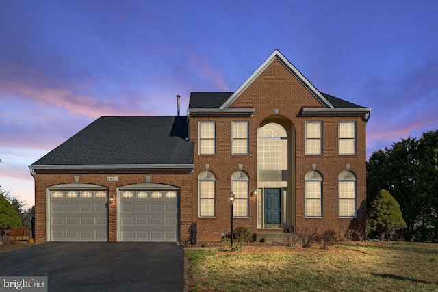 view of front of home featuring aphalt driveway, brick siding, a garage, and roof with shingles