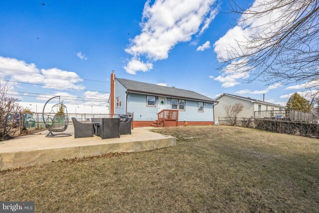 back of property with a yard, a patio, a chimney, and fence