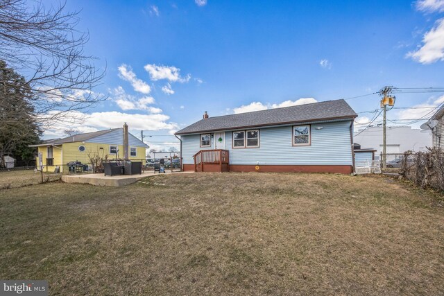 back of property with a patio, a lawn, fence, and a chimney