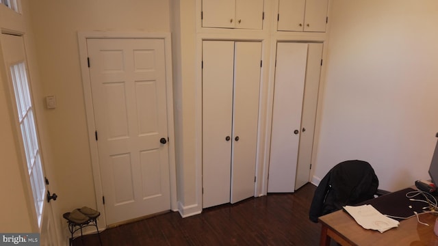 unfurnished office featuring dark wood-type flooring