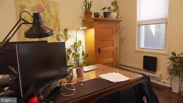 office featuring a baseboard heating unit and wood finished floors