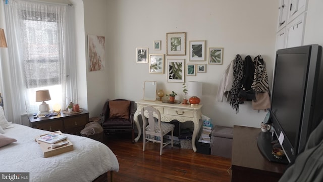 bedroom with dark wood-style floors