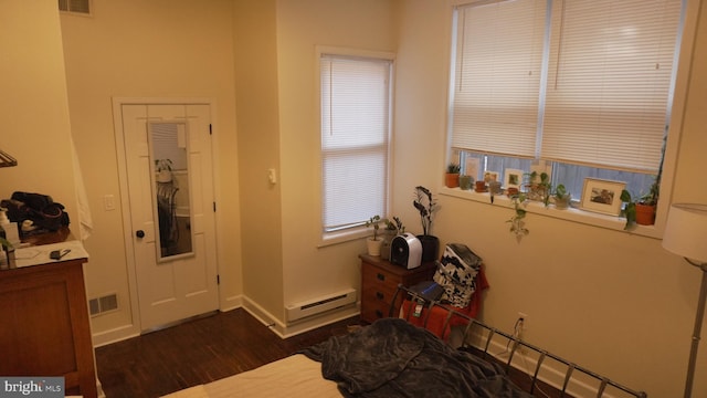 entrance foyer featuring dark wood-style floors, baseboard heating, baseboards, and visible vents