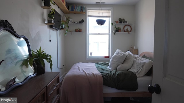 bedroom featuring visible vents and multiple windows