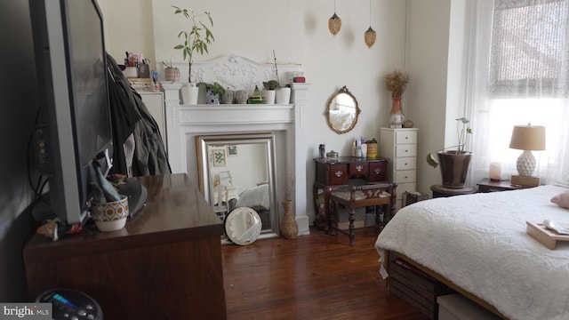 bedroom with dark wood-style floors