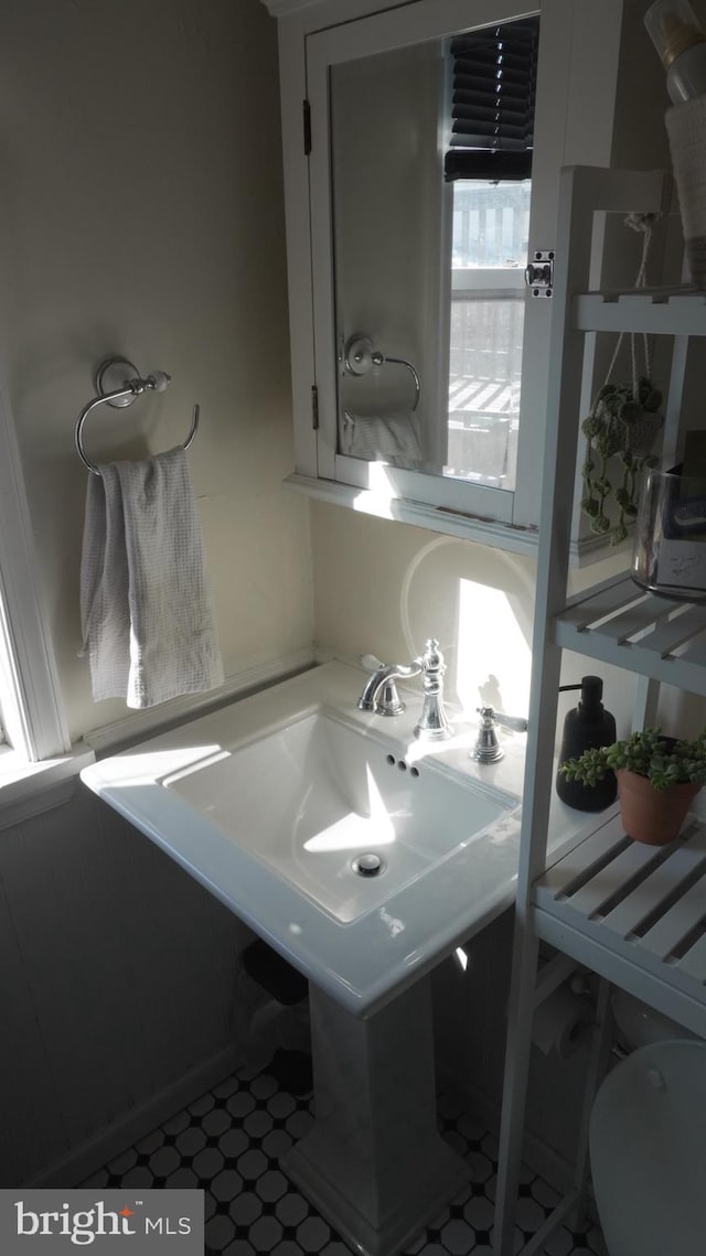 bathroom with tile patterned floors and a sink