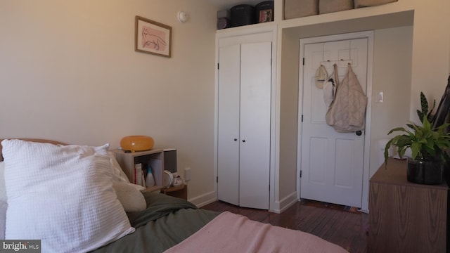 bedroom with hardwood / wood-style floors and baseboards